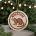 A round ornament with the word "MONGOOSE" printed on it, featuring a graphic of a brown mongoose.