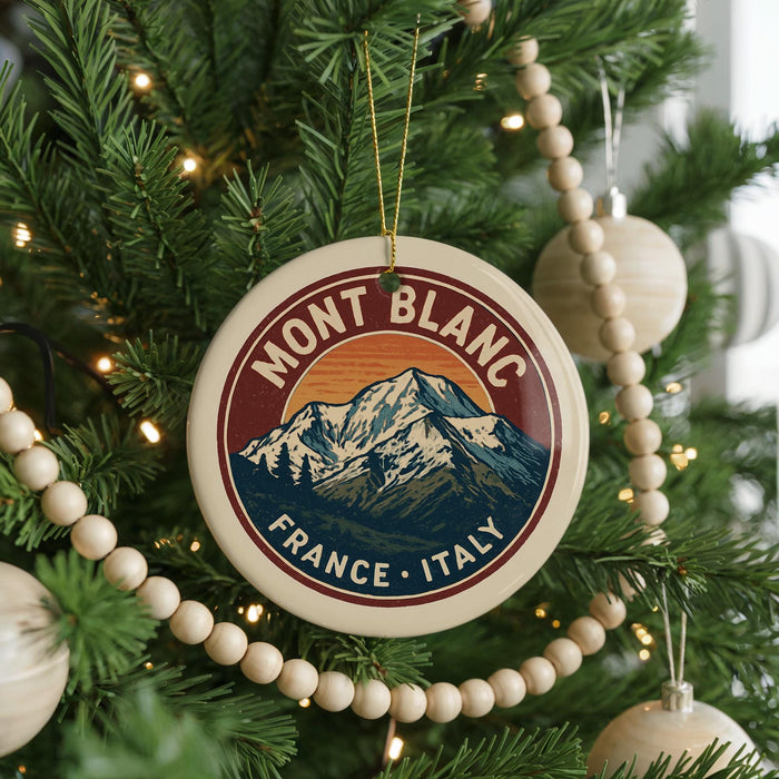 A round ornament on a Christmas tree, featuring a mountain landscape and the text "MONT BLANC FRANCE - ITALY".