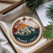 A round ornament with a mountain and pine tree design, featuring the text "MONT BLANC FRANCE ITALY".