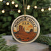 A circular ornament with the text "MONUMENT VALLEY U.S.A." and an illustration of Monument Valley, a famous landmark in the United States.