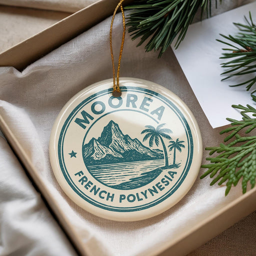 A circular ornament with the text "MOOREA FRENCH POLYNESIA" printed on it, hanging from a string.
