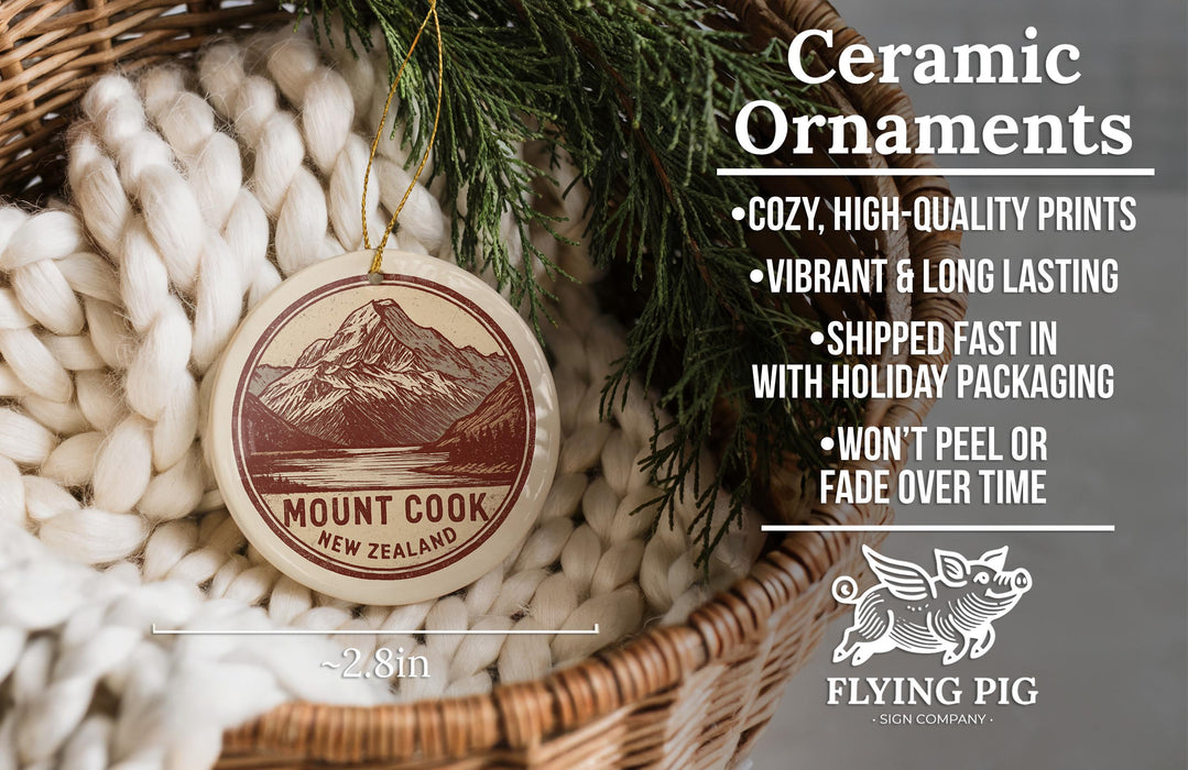 Ceramic ornaments, featuring a mountain landscape design, are displayed in a woven basket.
