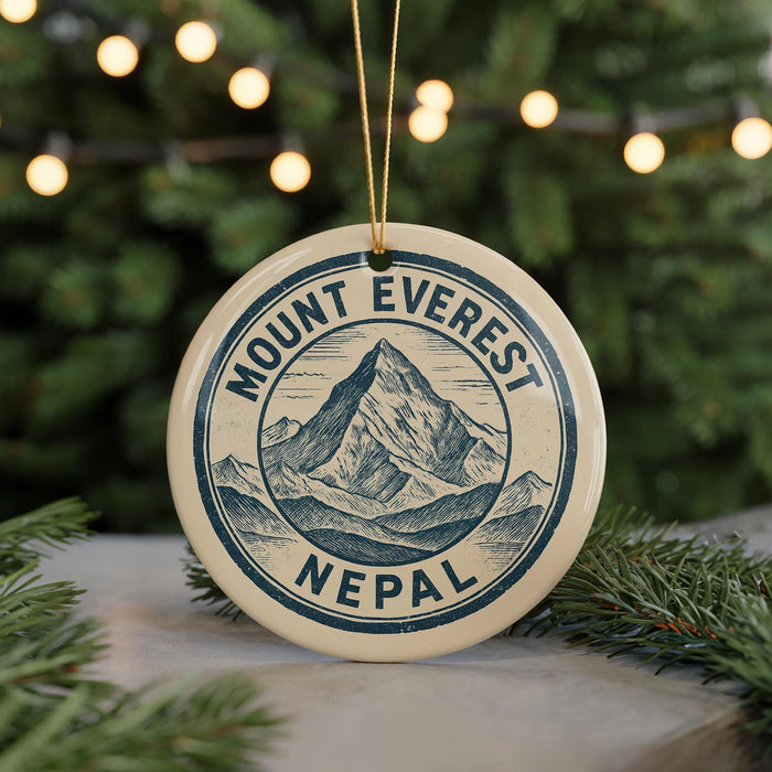 A circular ornament with the text "Mount Everest Nepal" printed on it, hanging from a string.