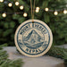 A circular ornament with the text "Mount Everest Nepal" printed on it, hanging from a string.