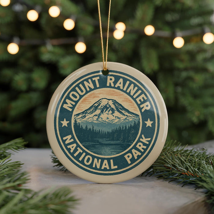 A circular ornament with the text "Mount Rainier National Park" and a mountain landscape design, hanging from a string.