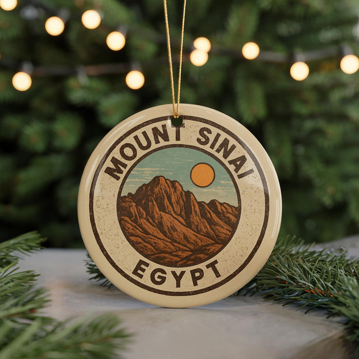 A circular ornament with the text "Mount Sinai Egypt" and an illustration of a mountain range, hanging from a string.