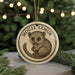 A round ornament featuring a cartoon image of a mouse with the text "MOUSE LEMUR" on it, hanging from a string.