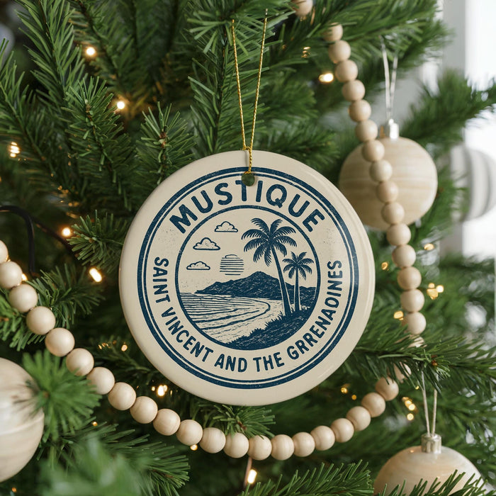 A Christmas tree decorated with ornaments, including a circular ornament with a palm tree design and the text "MUSTIQUE Saint Vincent and the Grenadines".