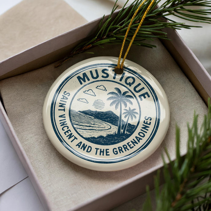 A circular ornament with the text "MUSTIQUE SAINT VINCENT AND THE GRENADAINES" printed on it, surrounded by pine branches.