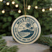 A circular ornament with the text "MUSTIQUE SAINT VINCENT AND THE GREMEN" and a graphic of a tropical beach and palm trees.