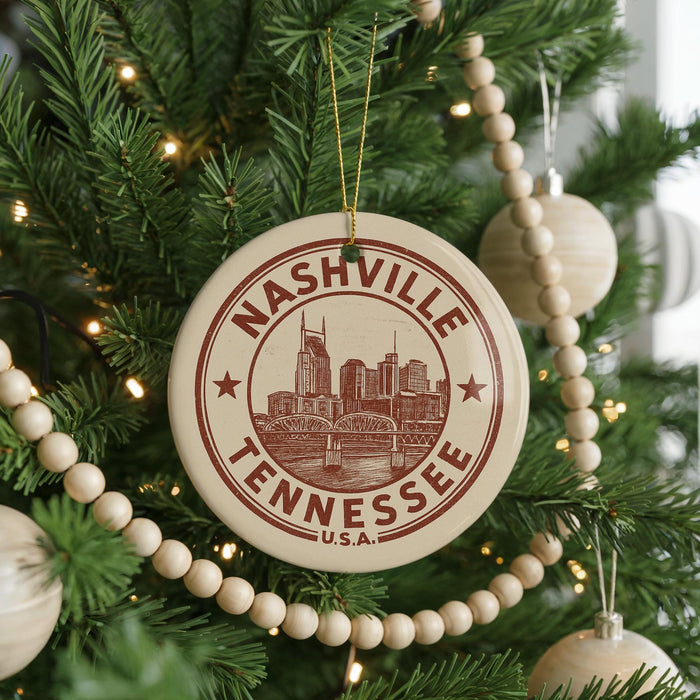 A Christmas tree decorated with ornaments, including a circular ornament with the text "Nashville, Tennessee" and a cityscape illustration.