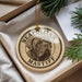 A round ornament with a dog image and the text "NEAPOLITAN MASTIFF" printed on it, hanging from a string.