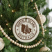 A Christmas tree decorated with ornaments, including a circular ornament with the text "NORFOLK ISLAND AUSTRALIA" and a tree-like design.
