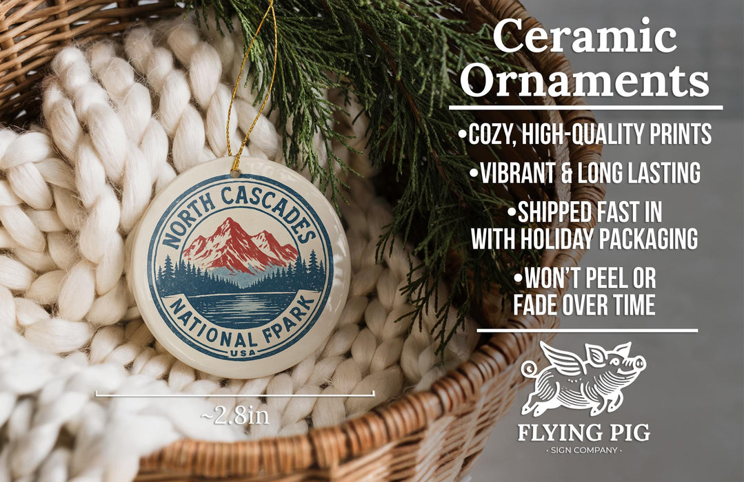 Ceramic ornaments, featuring a design of a mountain landscape with a lake, are displayed in a woven basket.