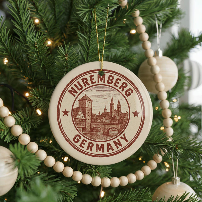A Christmas tree decorated with ornaments, including a circular ornament with the text "Nuremberg Germany" and a wooden bead decoration.