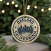A circular ornament with the text "OAKLAND CALIFORNIA U.S.A." printed on it, featuring a graphic of a city skyline.