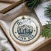 A circular ornament with the text "OGDEN UTAH USA" and an illustration of a mountain range, hanging from a string.
