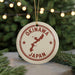 A circular ornament with the text "OKINAWA JAPAN" printed on it, featuring a map of Japan.