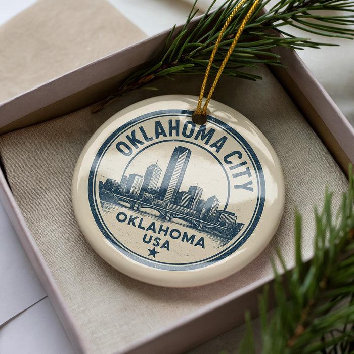 A circular ornament with the text "OKLAHOMA CITY, OKLAHOMA USA" printed on it, surrounded by pine branches.