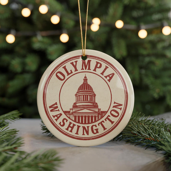 A circular ornament with the text "OLYMPIA WASHINGTON" and a graphic of the Washington State Capitol building, hanging from a string.