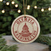 A circular ornament with the text "OLYMPIA WASHINGTON" and a graphic of the Washington State Capitol building, hanging from a string.