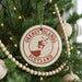 A Christmas tree decorated with ornaments, including a circular ornament with the text "ORKNEY ISLANDS SCOTLAND" and a map of the Orkney Islands.