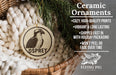 Ceramic ornaments, featuring a ceramic ornament with an Osprey image and text, placed in a wicker basket with pine branches.