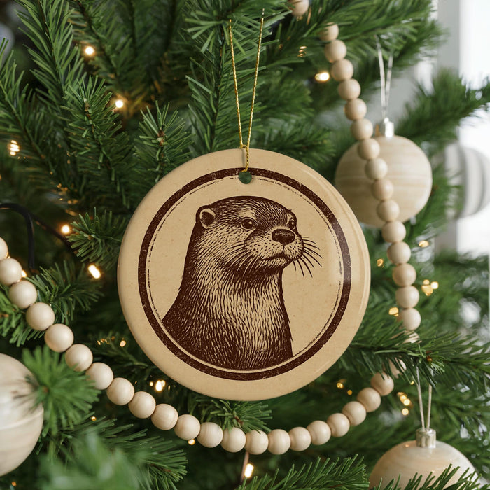 A Christmas tree decorated with ornaments, including a circular ornament featuring a close-up of an otter's face.