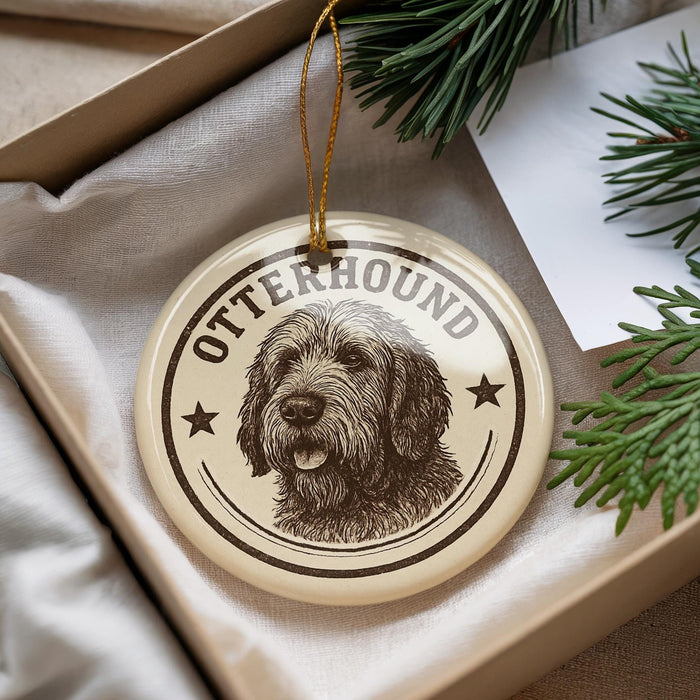 A circular ornament featuring a dog's head and the text "OTTERHOUND" is displayed in a box with pine branches.