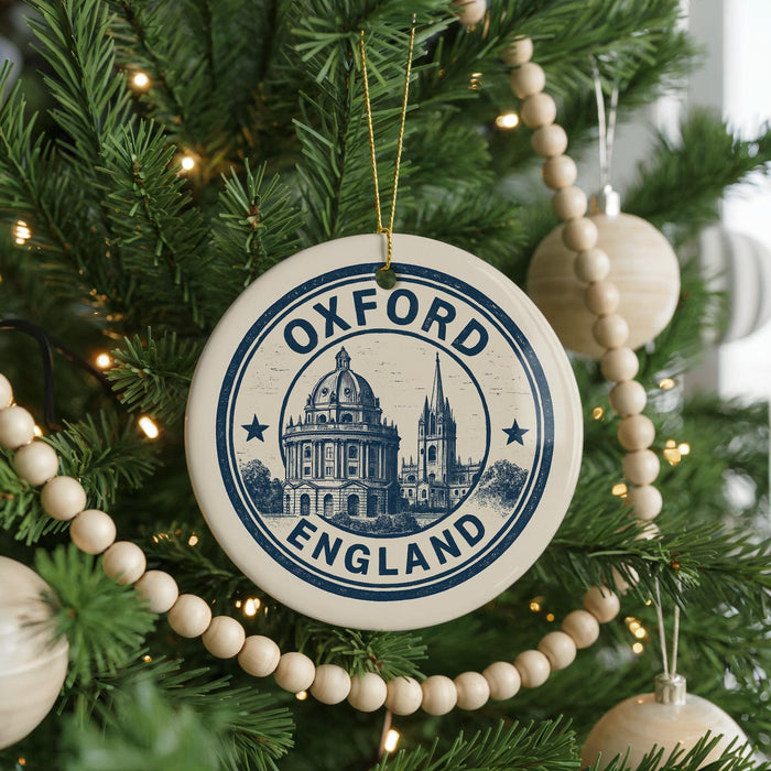 A Christmas tree decorated with ornaments, including a circular ornament with the text "Oxford, England" and a picture of a building.