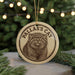 A circular ornament featuring a close-up image of a cat's face, with the text "PALLAS'S CAT" printed on it.