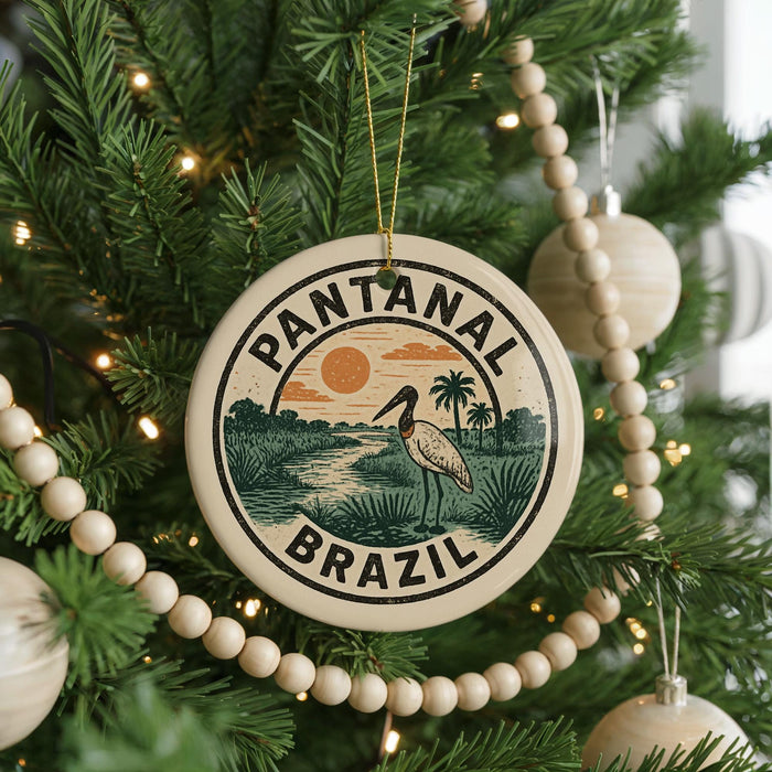 A circular ornament on a Christmas tree, featuring a bird and palm trees, with the text "PANTANAL BRASIL" around the edge.