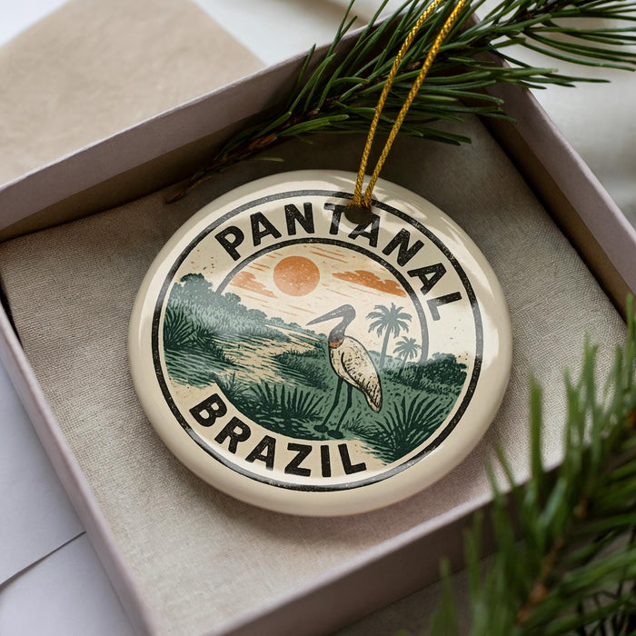 A circular ornament with the text "PANTANAL BRASIL" and an illustration of a bird standing in a tropical landscape.