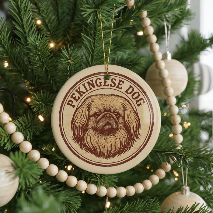 A Christmas tree decorated with ornaments, including a circular ornament with a picture of a dog's face and the text "Pekingese Dog".