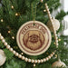 A Christmas tree decorated with ornaments, including a circular ornament with a picture of a dog's face and the text "Pekingese Dog".