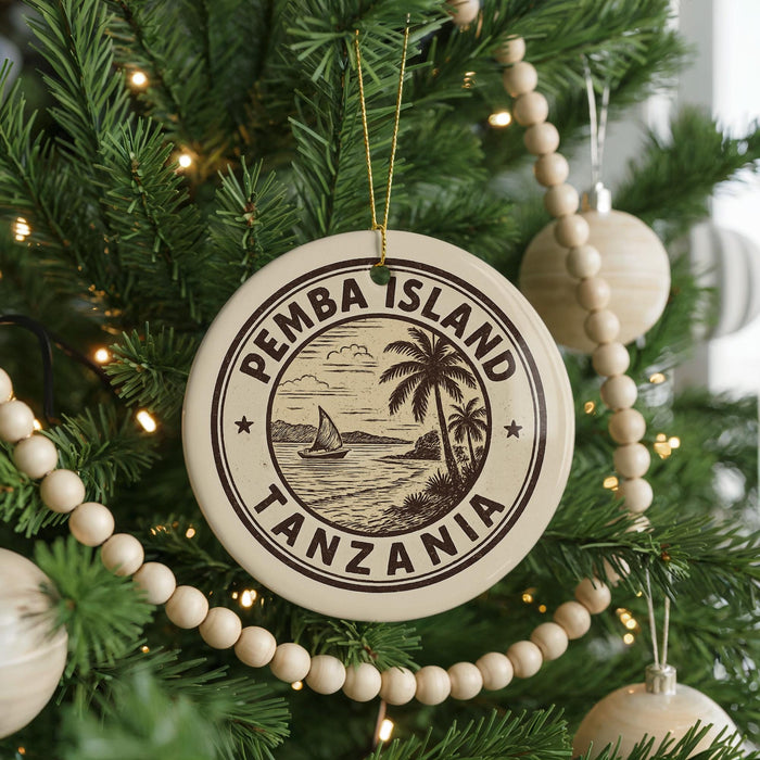 A circular ornament on a Christmas tree, featuring the text "PEMBA ISLAND TANZANIA" surrounded by a palm tree illustration.