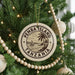 A circular ornament on a Christmas tree, featuring the text "PEMBA ISLAND TANZANIA" surrounded by a palm tree illustration.