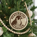 A Christmas tree decorated with ornaments, including a round ornament with a bird image and the text "Peregrine Falcon" around it.