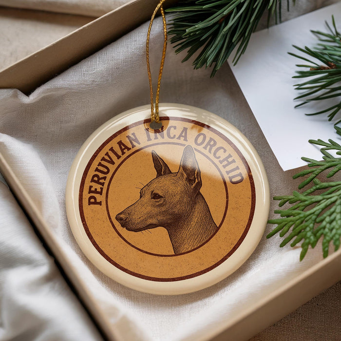 A round ornament with a dog's head on it, hanging from a string.