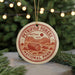 A circular ornament with the text "PETRIFIED FOREST NATIONAL PARK USA" printed on it, featuring an illustration of a forest scene.