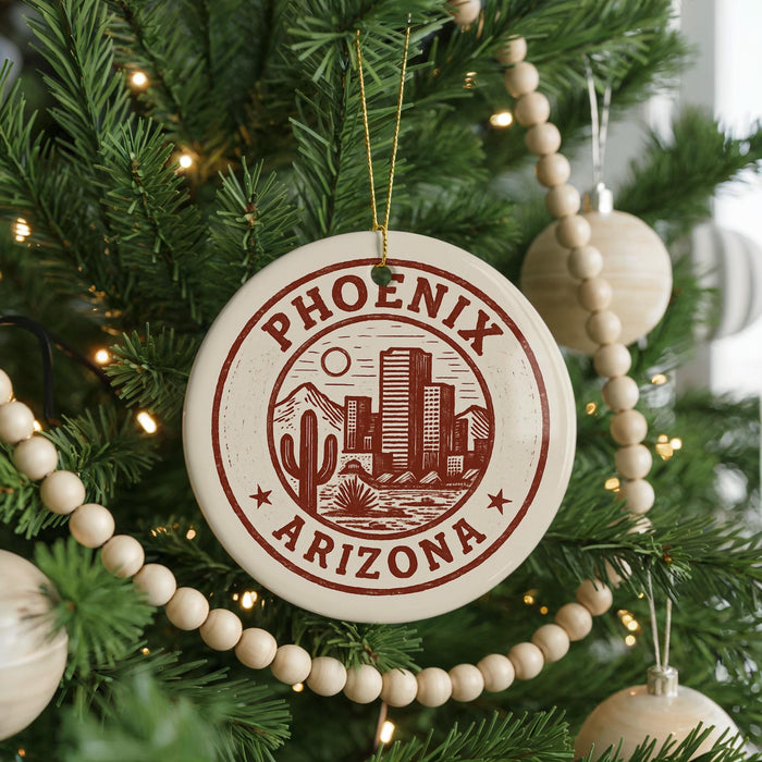 A Christmas tree decorated with ornaments, including a circular ornament with the text "PHOENIX ARIZONA" and a cactus design.