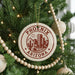 A Christmas tree decorated with ornaments, including a circular ornament with the text "PHOENIX ARIZONA" and a cactus design.