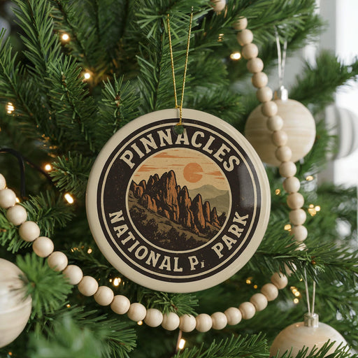 A Christmas tree decorated with ornaments, including a circular ornament with the text "PINNACLES NATIONAL PARK" and a mountain landscape.