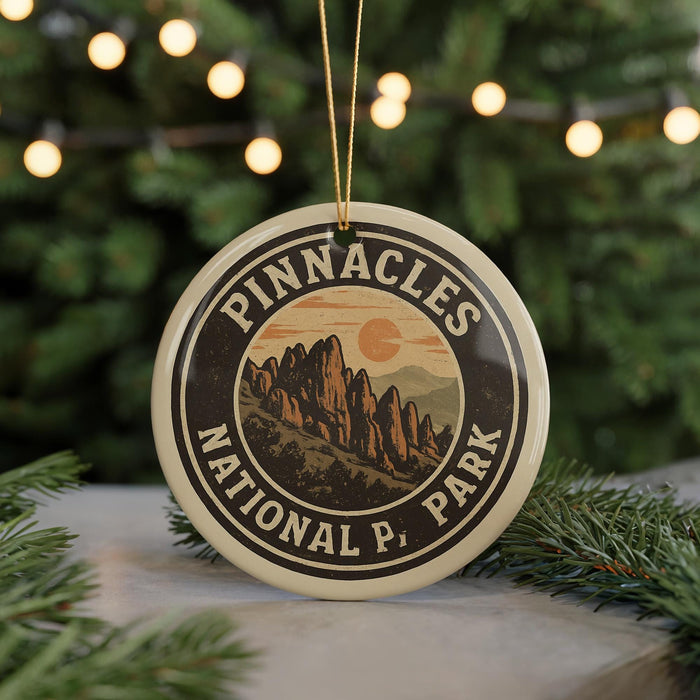 A circular ornament with the text "PINNACLES NATIONAL PARK" and an illustration of mountains, hanging from a string.