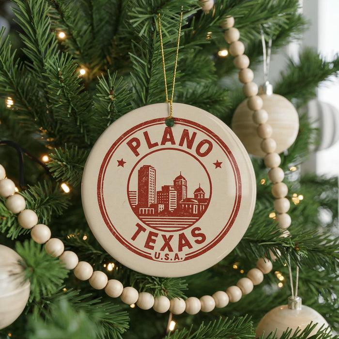 A Christmas tree decorated with ornaments, including a circular ornament with the text "PLANO TEXAS U.S.A."