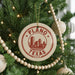 A Christmas tree decorated with ornaments, including a circular ornament with the text "PLANO TEXAS U.S.A."