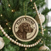 A Christmas tree decorated with ornaments, including a circular ornament with a hound dog image and the text "PLOTT HOUND".
