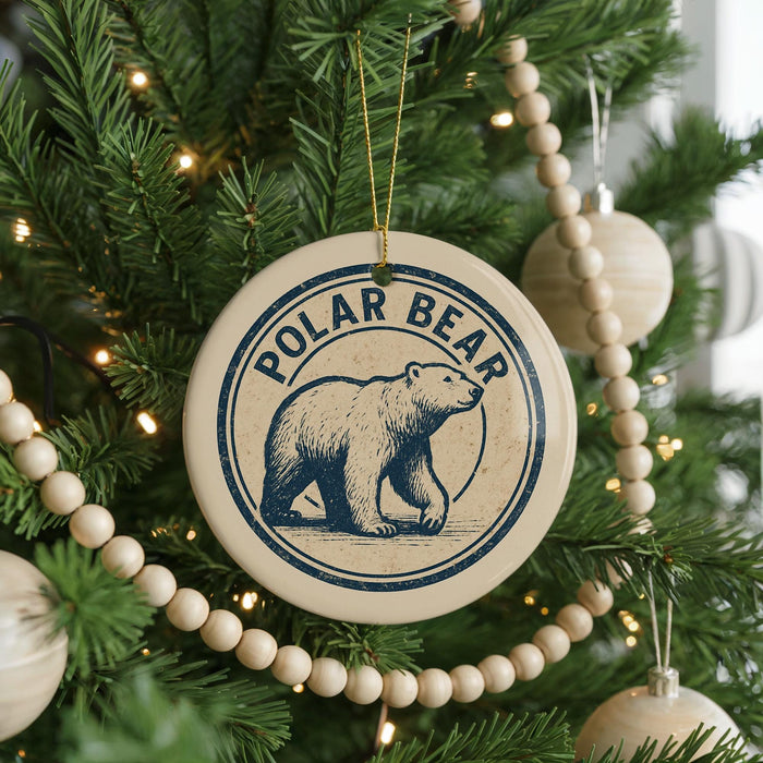 A Christmas tree decorated with ornaments, including a circular ornament with a polar bear image and the text "POLAR BEAR" on it.