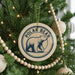 A Christmas tree decorated with ornaments, including a circular ornament with a polar bear image and the text "POLAR BEAR" on it.