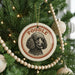 A Christmas tree decorated with ornaments, including a circular ornament with a poodle image and the word "Poodle" written on it.